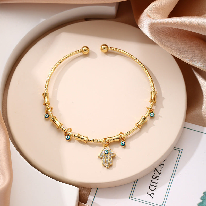 Glücksarmreifen im Gold-Look mit blauen Augen