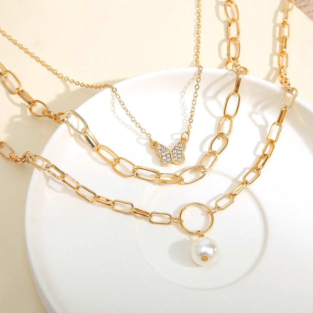 Goldenes Layering-Ketten-Set mit Schmetterling und Perle